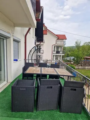 a balcony with a table and chairs on a house at Apartman Villa E&M in Bihać
