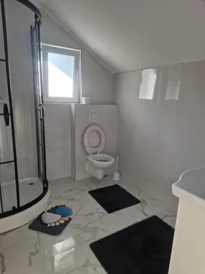 a bathroom with a shower and a toilet and a sink at Apartman Villa E&M in Bihać