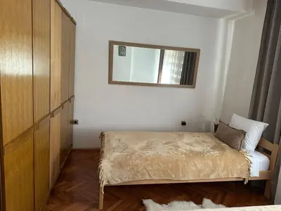 a small bedroom with a bed and a mirror at Apartman Amy Visoko in Visoko
