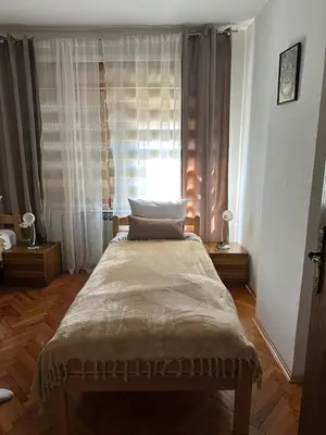 a bedroom with a large bed in front of a window at Apartman Amy Visoko in Visoko