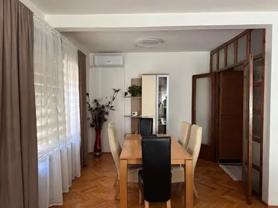 a dining room with a wooden table and chairs at Apartman Amy Visoko in Visoko