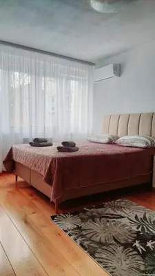 a bedroom with a large bed in front of a window at Banjaluka Centar1 in Banja Luka