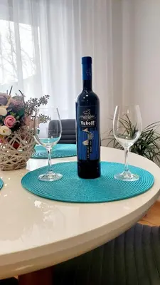 a bottle of wine sitting on a table with two glasses at Banjaluka Centar1 in Banja Luka