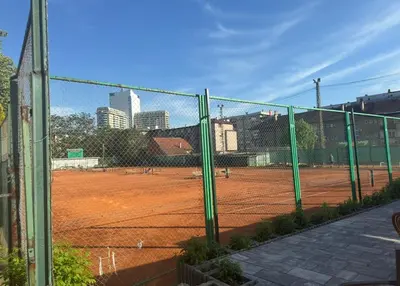 a tennis court with a fence and a tennis court at Apartment Esmihan in Tuzla