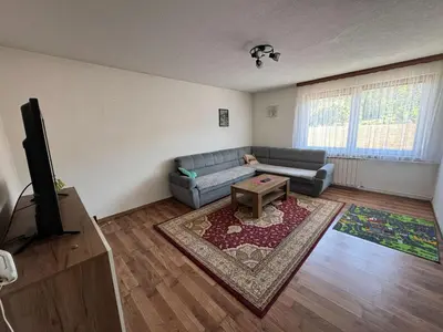 a living room with a couch and a tv at Apartment Esmihan in Tuzla