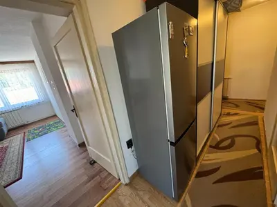 a large silver refrigerator in a room with a hallway at Apartment Esmihan in Tuzla