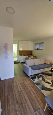 a living room with a bed and a kitchen at VAL apartmani in Jajce
