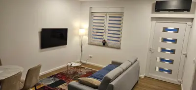 a living room with a couch and a table at VAL apartmani in Jajce