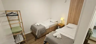 a small room with two beds and a ladder at VAL apartmani in Jajce