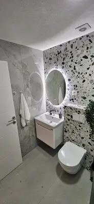 a bathroom with a toilet and a sink and a mirror at VAL apartmani in Jajce