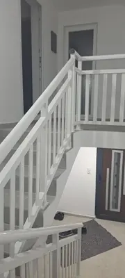 a white staircase in a room with a door at Apartmani Donji Vakuf in Donji Vakuf