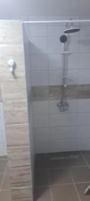 a shower with a glass door in a bathroom at Apartmani Donji Vakuf in Donji Vakuf