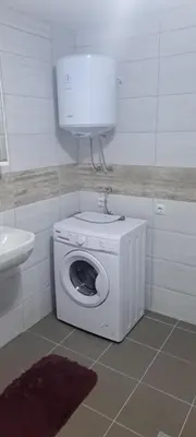 a washing machine in a bathroom with a sink at Apartmani Donji Vakuf in Donji Vakuf