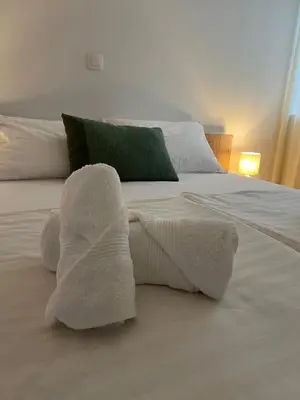 a white bed with a stuffed animal on it at Apartmani Pervan in Livno