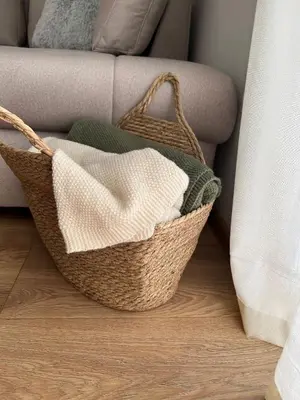 a basket sitting on the floor next to a couch at Apartmani Pervan in Livno