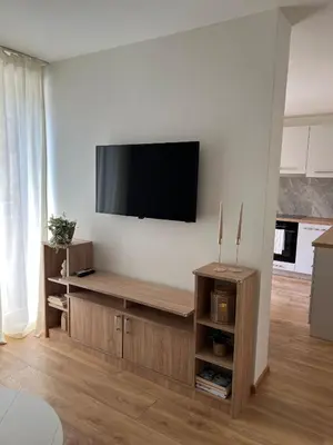a living room with a flat screen tv on a wall at Apartmani Pervan in Livno
