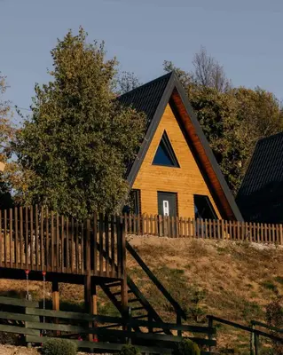 a house with a wooden fence in front of it at Kraljičini konaci in Doboj