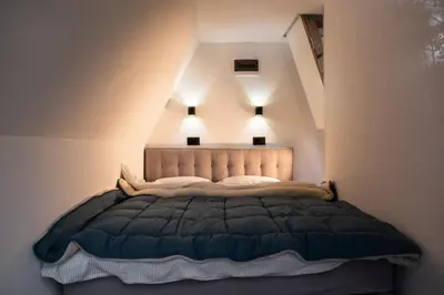 a bedroom with a bed with lights above it at Kraljičini konaci in Doboj