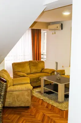 a living room with a couch and a table at La Casa in Prijedor