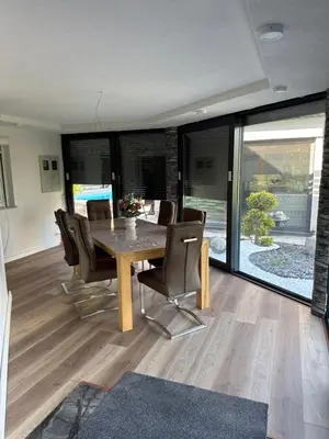 a dining room with a wooden table and chairs at Villa Amy in Bihać
