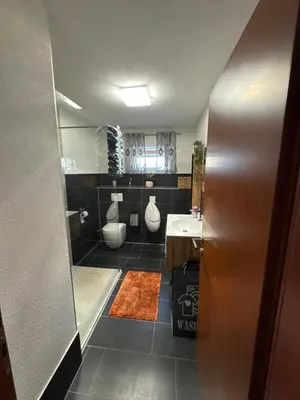 a bathroom with two toilets and a sink at Villa Amy in Bihać