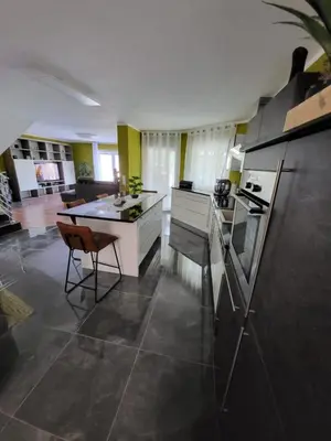 a kitchen with a counter and a table and chairs at Villa Amy in Bihać