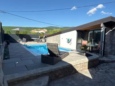 a house with a swimming pool and a patio at Villa Amy in Bihać
