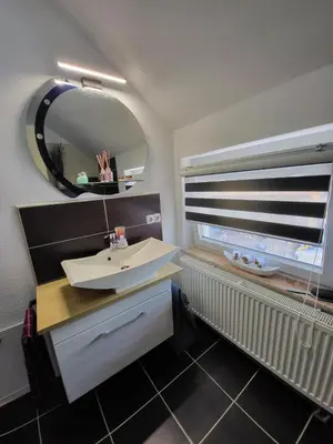a bathroom with a sink and a mirror at Villa Amy in Bihać