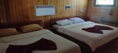 a room with two beds with towels on them at Weekend house Mali Raj in Visoko