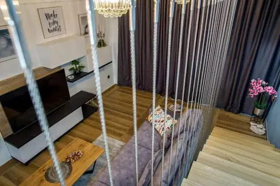 a living room with a couch and a chandelier at Villa Imperio Deluxe in Brekovica