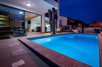 a swimming pool in the middle of a house at Villa Imperio Deluxe in Brekovica