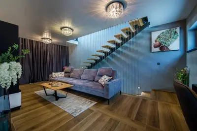 a living room with a couch and a staircase at Villa Imperio Deluxe in Brekovica