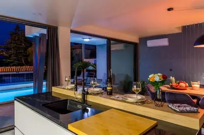 a kitchen with a counter with glasses of wine at Villa Imperio Deluxe in Brekovica