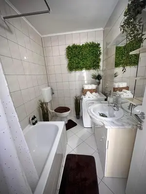 a bathroom with a tub and a sink and a toilet at Apartman TEA in Željeznička Stanica Bosanski Šamac