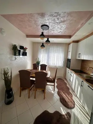 a kitchen and dining room with a table and chairs at Apartman TEA in Željeznička Stanica Bosanski Šamac