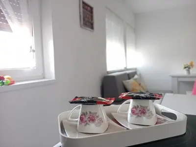 two hello kitty clocks sitting on top of a table at Apartman Nera in Gradačac