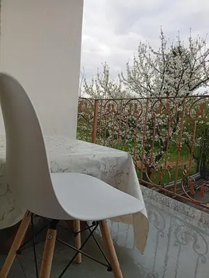 a white chair sitting on top of a balcony at Apartman Nera in Gradačac