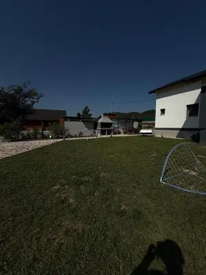 a persons shadow in a yard with a frisbee at UNA Escape in Glodina