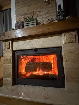 a brick oven with a fire inside of it at Log Cabin Plavšić - Vikendica Plavšić in Šipovo