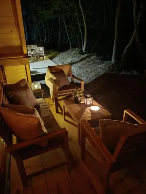 a living room with two chairs and a coffee table at Una Olympic House in Lilaci