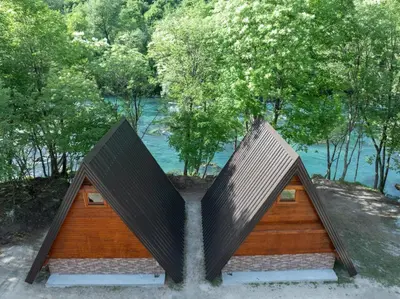 a house with a triangular roof with a waterfall at Una Olympic House in Lilaci