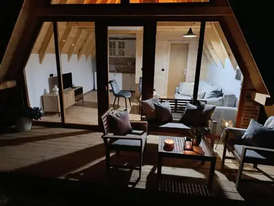 a living room with a couch and a table at Una Olympic House in Lilaci