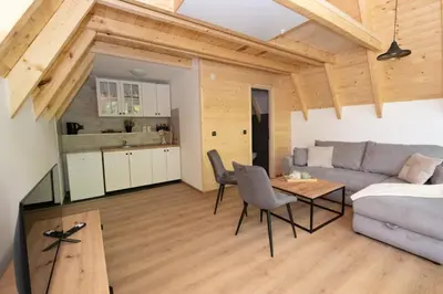 a living room with a couch and a table at Una Olympic House in Lilaci