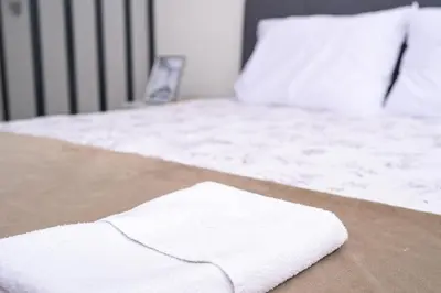 a white towel sitting on top of a bed at Ćato s cottage in Bravnice