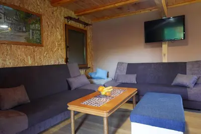 a living room with two couches and a coffee table at Ranch Una Soul in Glodina
