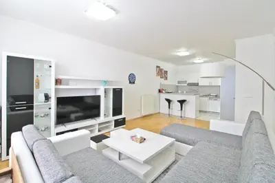 a living room with a couch and a table at Apartman Slani San in Tuzla