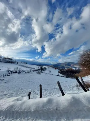 a snowy field with a fence in the snow at Villa Alyanna in Rankovići