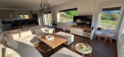 a living room with a couch and a flat screen tv at Villa Alyanna in Rankovići