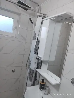 a white bathroom with a sink and a mirror at Apartmani Elix II in Ivišovo Greblje