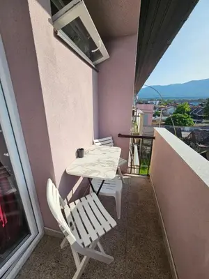 a table and chairs on the balcony of a building at Apartman Annie in Bihać